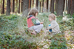 Kids picking berries in a forest