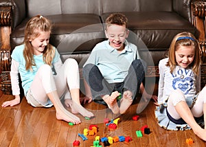 Kids pickup up blocks with feet