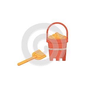 Kids plastic bucket with beach sand and small spade. Childrens summer toys, shovel and red pot with handle for playing