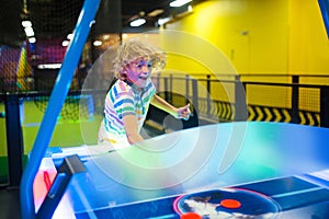 Kids play air hockey. Fun arcade games