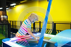 Kids play air hockey. Fun arcade games