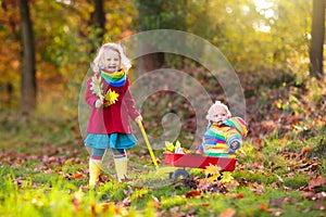 Kids play in autumn park. Children outdoor in fall