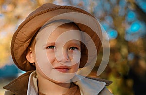 Kids play in autumn park. Children portrait with yellow leaves. Child boy with oak and maple leaf outdoor. Fall foliage