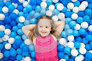 Kids play in ball pit. Child playing in balls pool