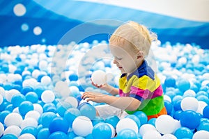 Kids play in ball pit. Child playing in balls pool