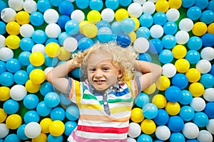 Kids play in ball pit. Child playing in balls pool