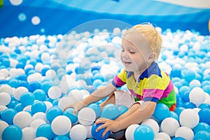 Kids play in ball pit. Child playing in balls pool