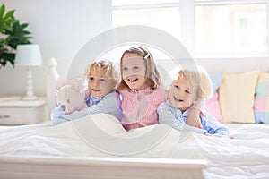 Kids play in bed. Children at home