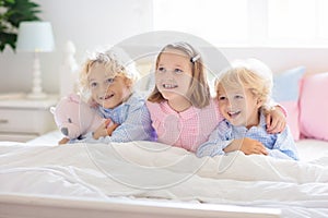 Kids play in bed. Children at home