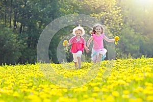 Kids play. Child in dandelion field. Summer flower