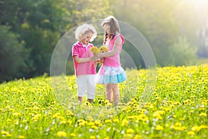 Kids play. Child in dandelion field. Summer flower