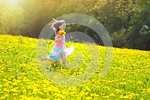 Kids play. Child in dandelion field. Summer flower