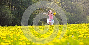 Kids play. Child in dandelion field. Summer flower