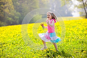 Kids play. Child in dandelion field. Summer flower