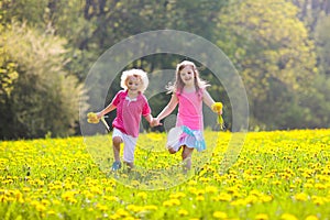 Kids play. Child in dandelion field. Summer flower