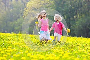 Kids play. Child in dandelion field. Summer flower