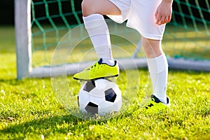 Kids play football. Child at soccer field.