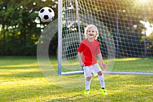 Kids play football. Child at soccer field