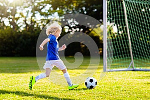 Kids play football. Child at soccer field