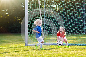 Kids play football. Child at soccer field