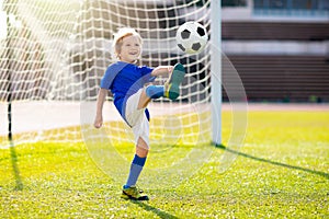 Kids play football. Child at soccer field