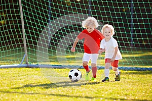 Kids play football. Child at soccer field