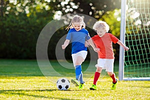 Kids play football. Child at soccer field