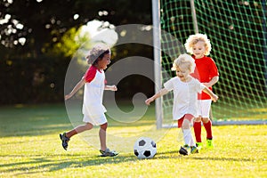 Kids play football. Child at soccer field