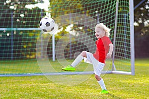 Kids play football. Child at soccer field