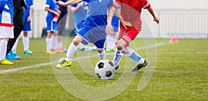 Kids play football on the soccer pitch