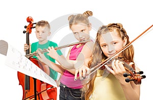 Kids play musical instruments on white background