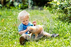 Kids play with puppy. Children and dog in garden