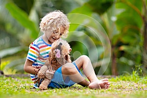 Kids play with puppy. Children and dog in garden