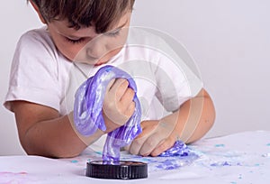 Kids play with slime. Boy stretch handgum or toy slime.