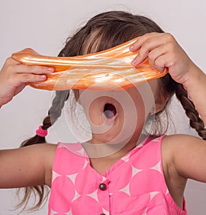 Kids play with slime. Girl stretch handgum or toy slime.