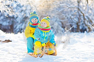 Kids play in snow. Winter sled ride for children