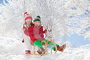 Kids play in snow. Winter sled ride for children