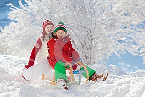 Kids play in snow. Winter sled ride for children