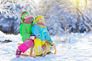 Kids play in snow. Winter sled ride for children