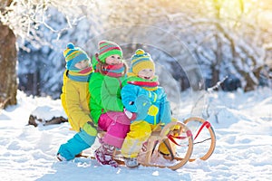 Kids play in snow. Winter sled ride for children