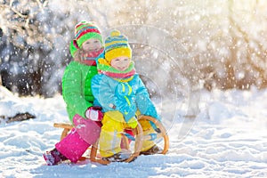 Kids play in snow. Winter sled ride for children