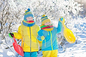 Kids play in snow. Winter sled ride for children