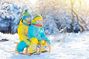 Kids play in snow. Winter sled ride for children