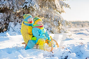 Kids play in snow. Winter sled ride for children