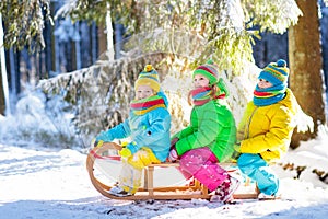 Kids play in snow. Winter sled ride for children