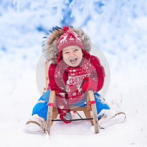 Kids play in snow. Winter sleigh ride for children