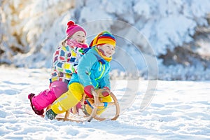 Kids play in snow. Winter sleigh ride for children