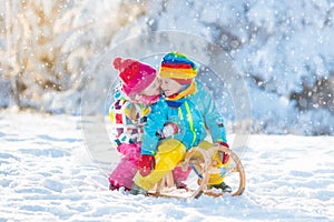 Kids play in snow. Winter sleigh ride for children