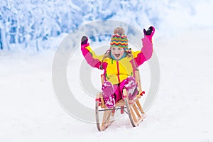 Kids play in snow. Winter sleigh ride for children