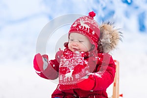 Kids play in snow. Winter sleigh ride for children